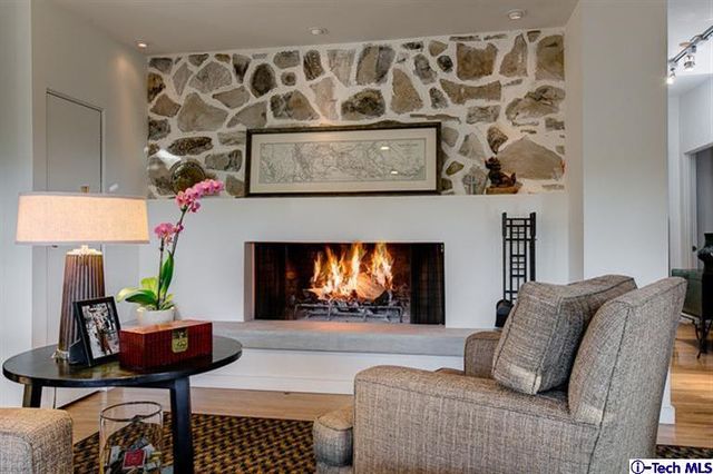 a living room with a book shelf and a book shelf