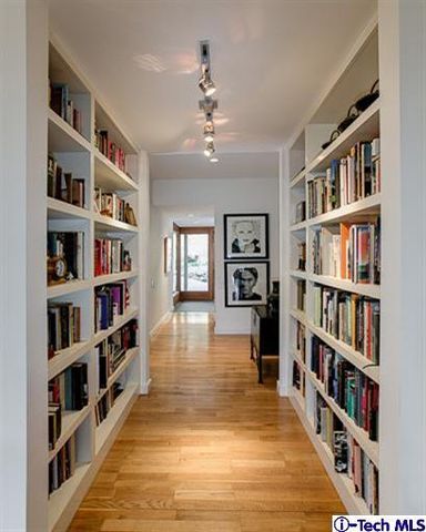 a living room with lots of furniture and a book shelf