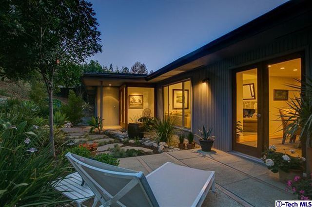 a view of house with backyard porch and outdoor seating