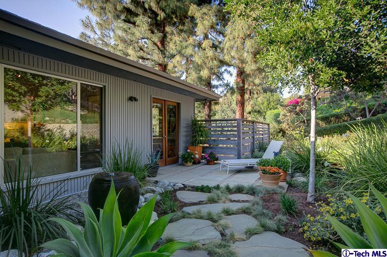 385 Manford Way Pasadena, CA 91105 - Photo 41 of 44 a backyard of a house with lots of green space and fountain
