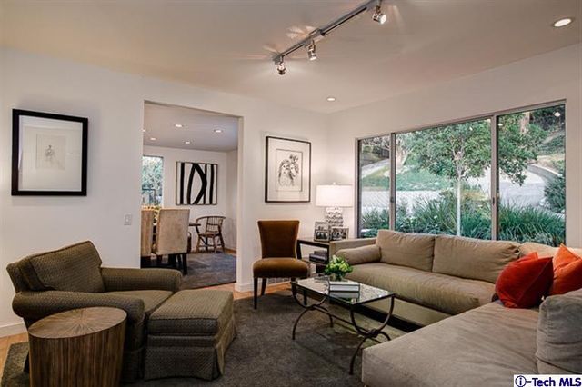 a dining room with furniture a window and a flat screen tv
