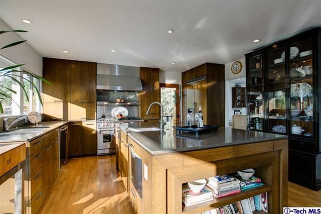 a table and chairs in a room with kitchen view