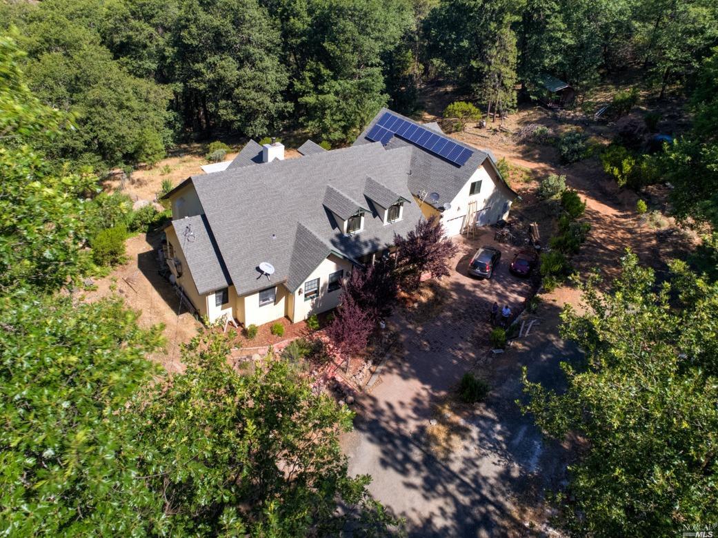 a view of a house with a yard and tree s