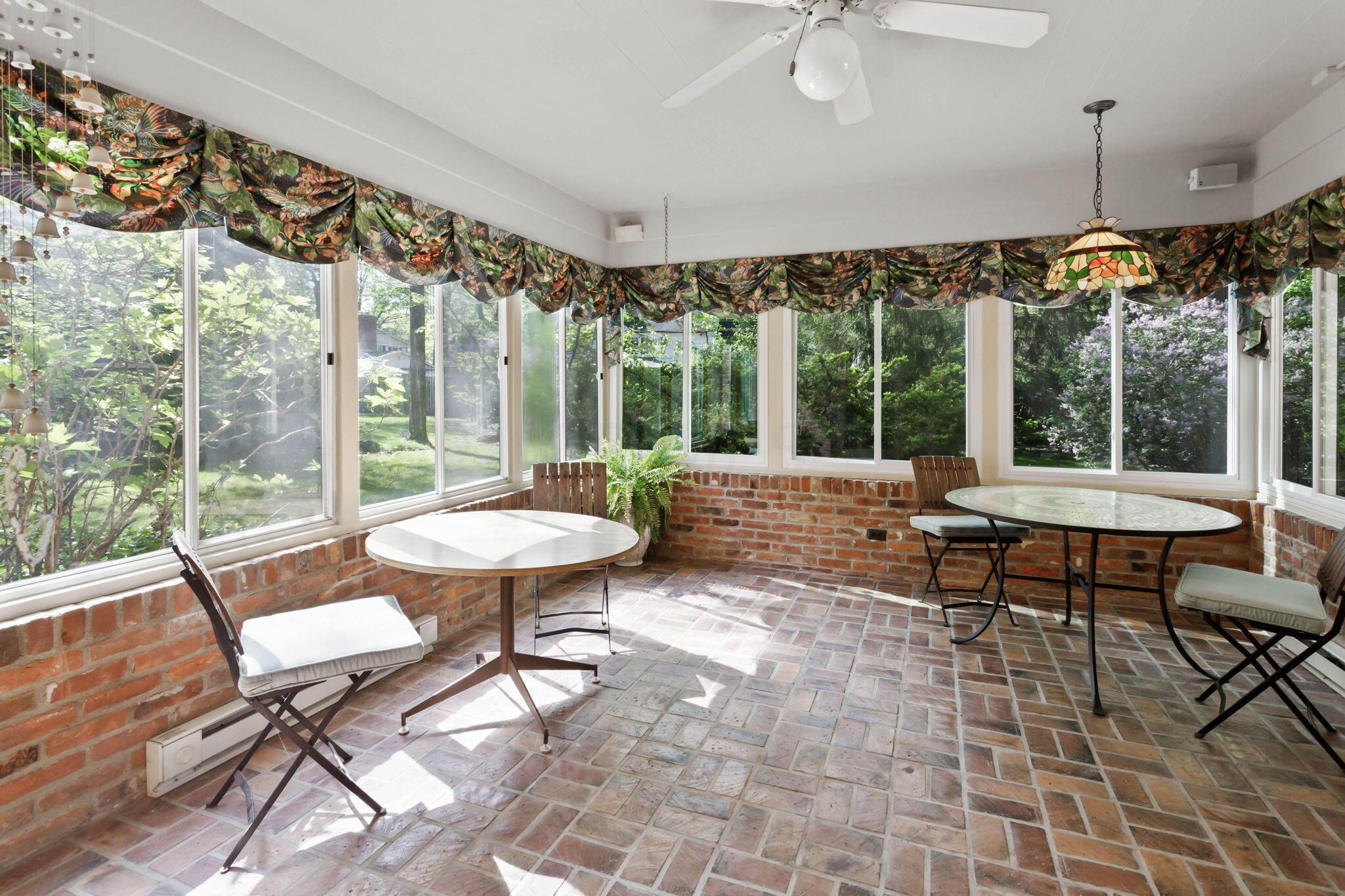 2111 Cheltenham Road Columbus, OH 43220 - Photo 17 of 64 Walls of windows and brick flooring are a part of this spacious 4 season room.