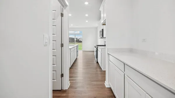 a view of a hallway with wooden floor