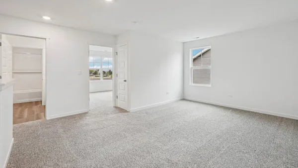 an empty room with windows and closet