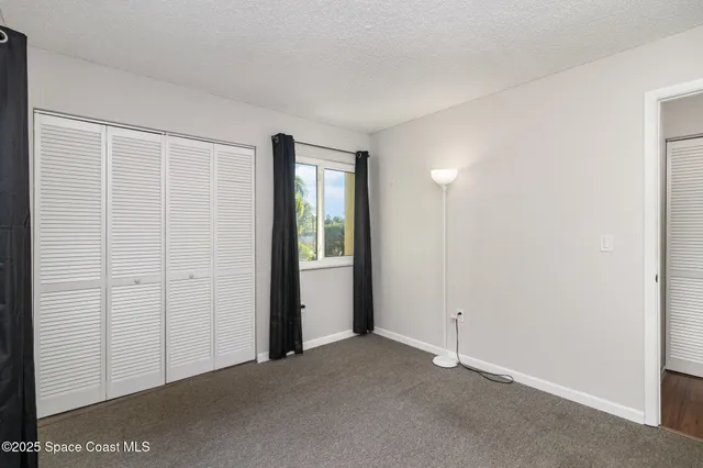 an empty room with closet area