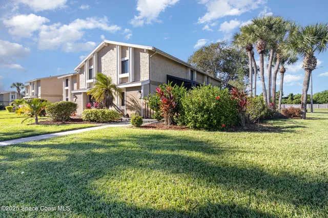 a front view of house with yard and green space