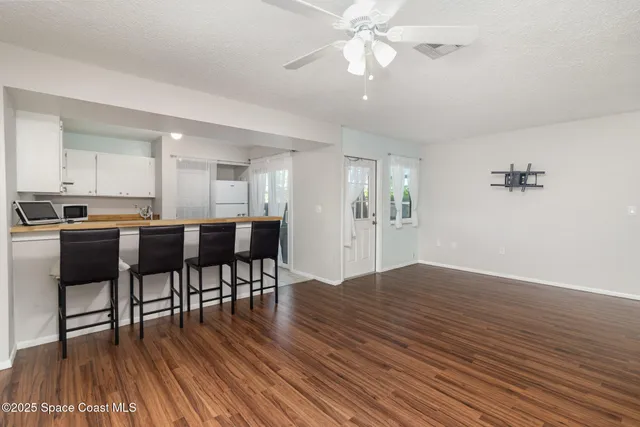 a view of kitchen with cabinets and wooden floor