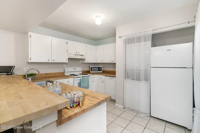 a kitchen with stainless steel appliances granite countertop refrigerator sink and cabinets