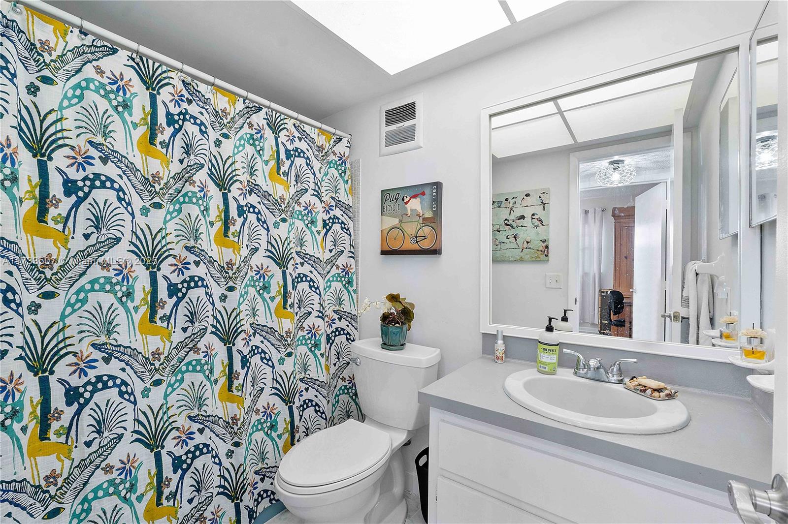 2751 East Golf Boulevard, Unit 2029 Pompano Beach, FL 33064 - Photo 11 of 24 a bathroom with a toilet sink and mirror