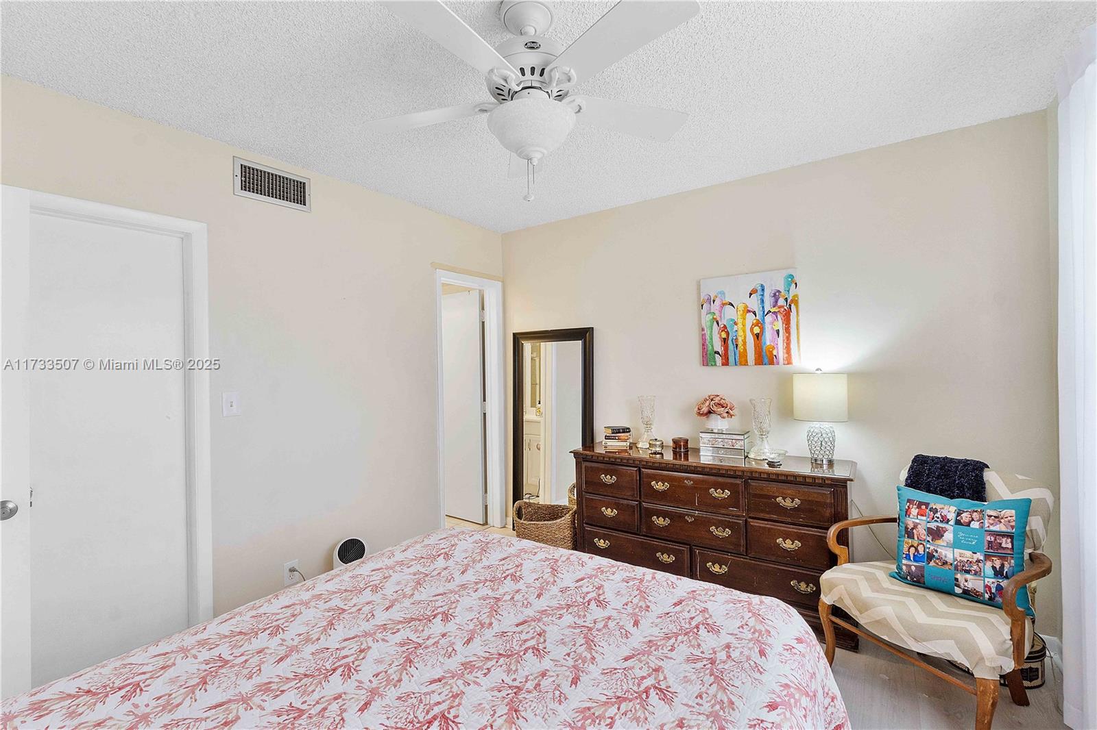 2751 East Golf Boulevard, Unit 2029 Pompano Beach, FL 33064 - Photo 13 of 24 a bedroom with a bed dresser and a window