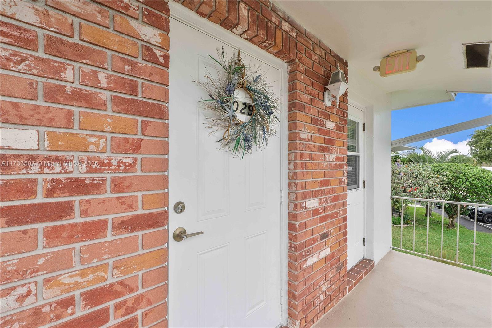 2751 East Golf Boulevard, Unit 2029 Pompano Beach, FL 33064 - Photo 15 of 24 a view of a door and with windows