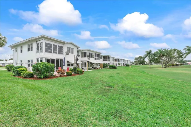 a view of a house with a backyard porch and sitting area