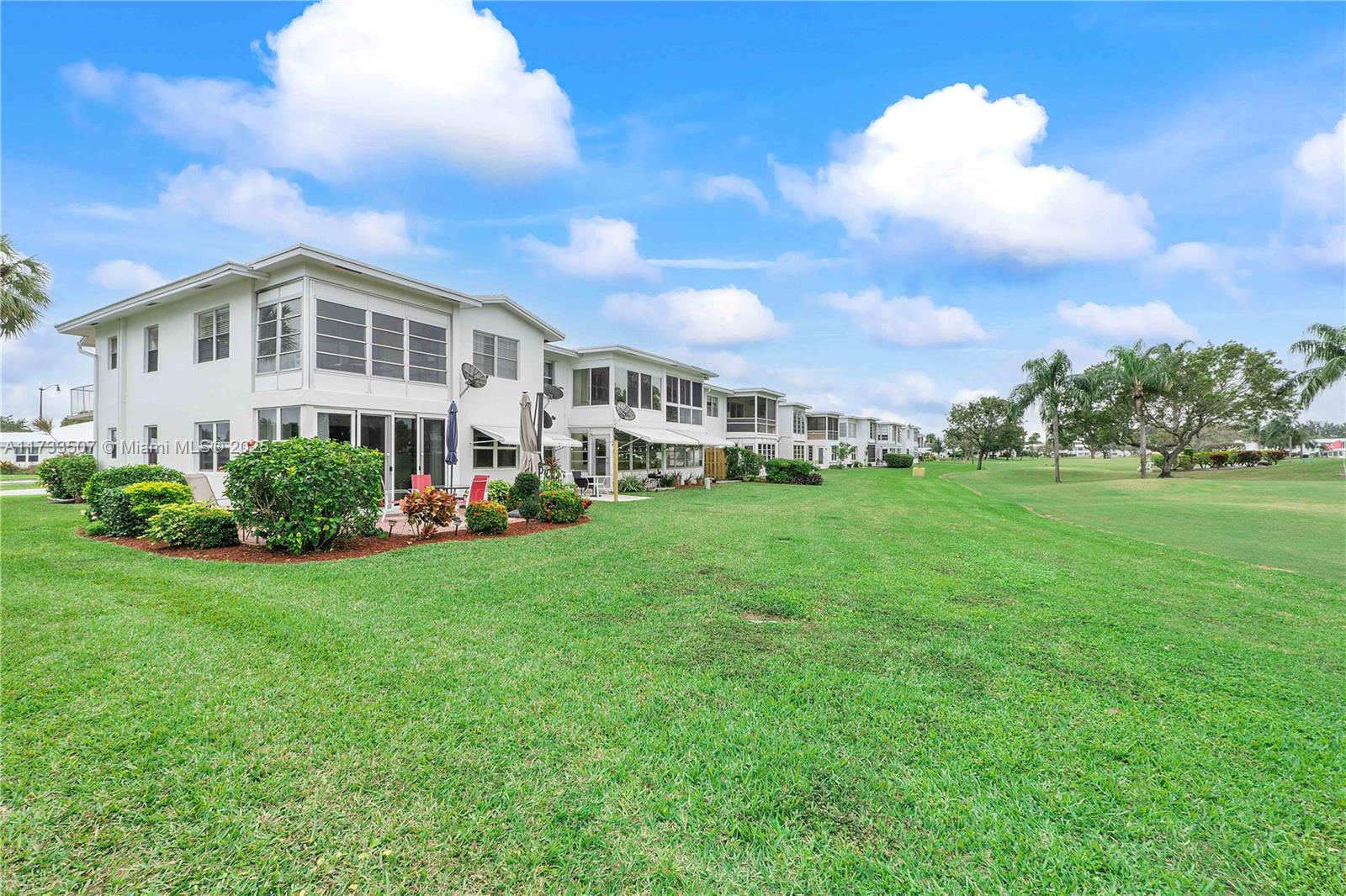 2751 East Golf Boulevard, Unit 2029 Pompano Beach, FL 33064 - Photo 17 of 24 a view of a house with a backyard porch and sitting area