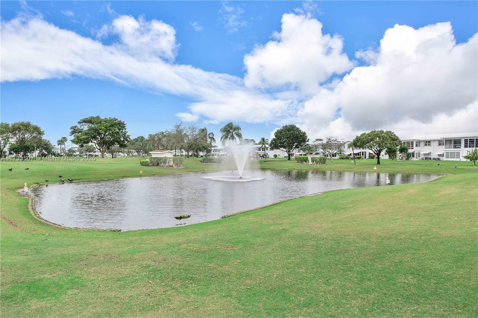 2751 East Golf Boulevard, Unit 2029 Pompano Beach, FL 33064 - Photo 22 of 24 a view of a lake with a big yard