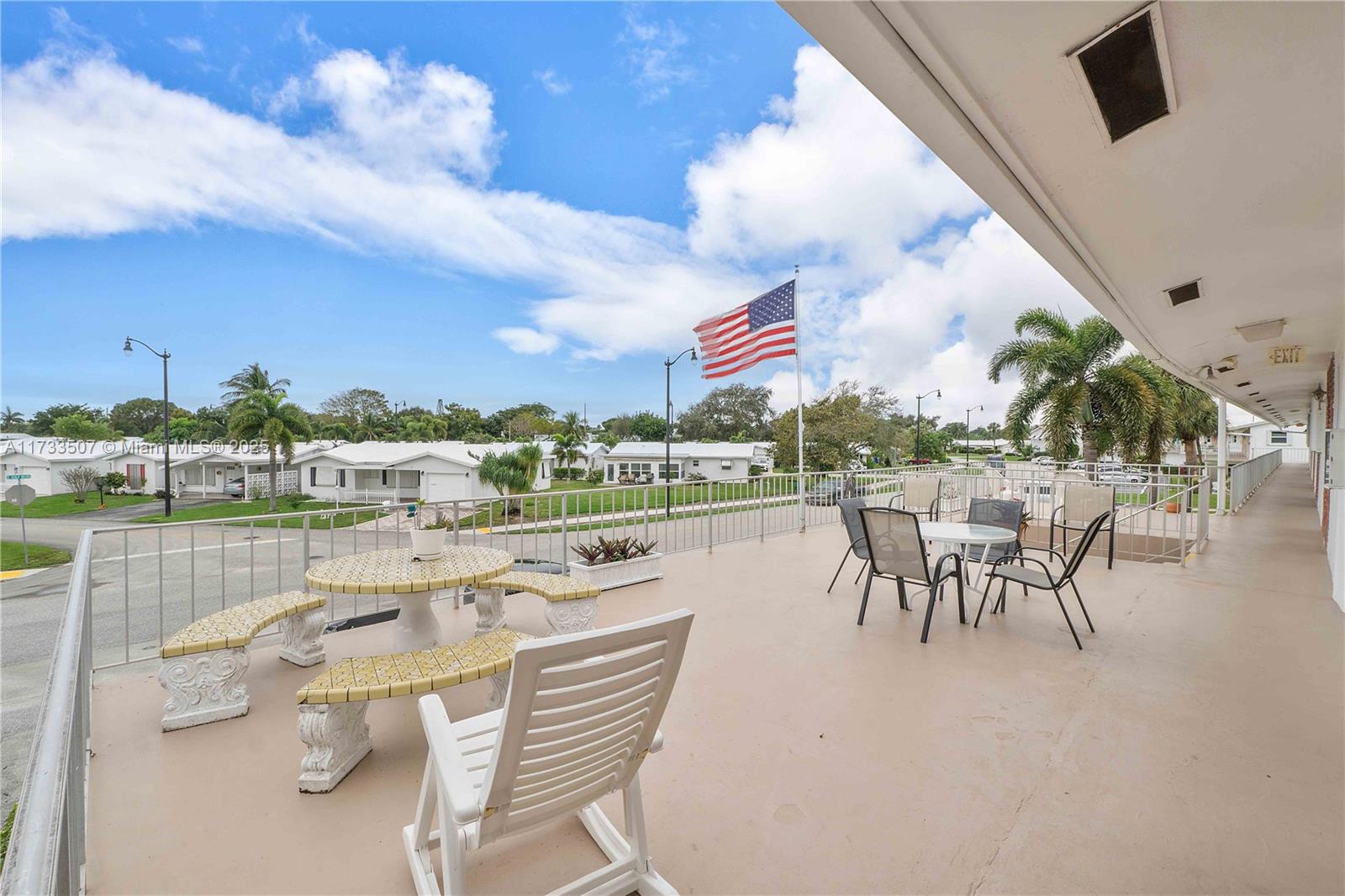 2751 East Golf Boulevard, Unit 2029 Pompano Beach, FL 33064 - Photo 23 of 24 a balcony with furniture and a lake view