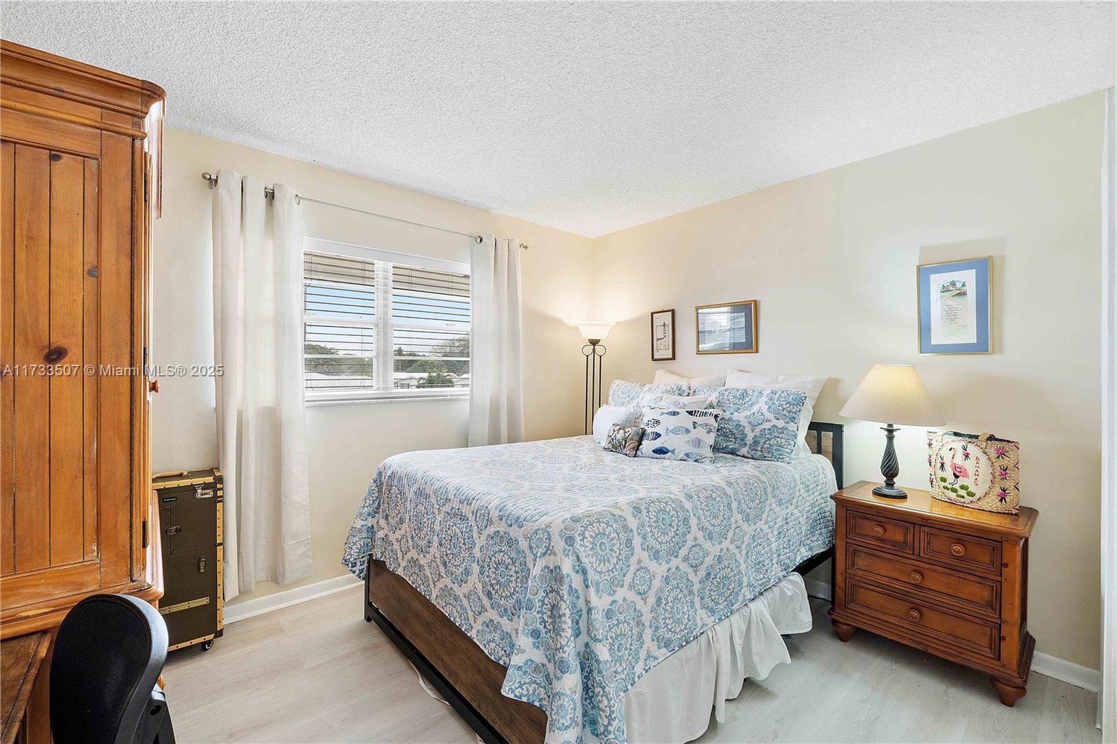 2751 East Golf Boulevard, Unit 2029 Pompano Beach, FL 33064 - Photo 9 of 24 a bedroom with a bed and a window