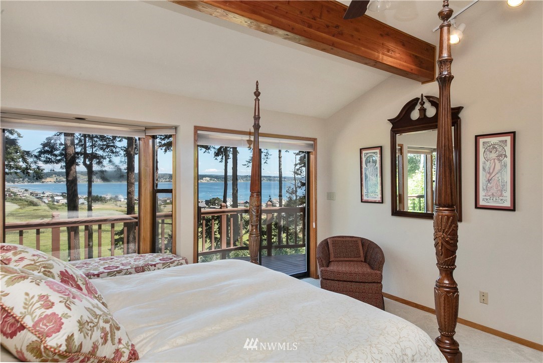 6188 Double Bluff Road Freeland, WA 98249 - Photo 29 of 40 a bedroom with furniture and large windows