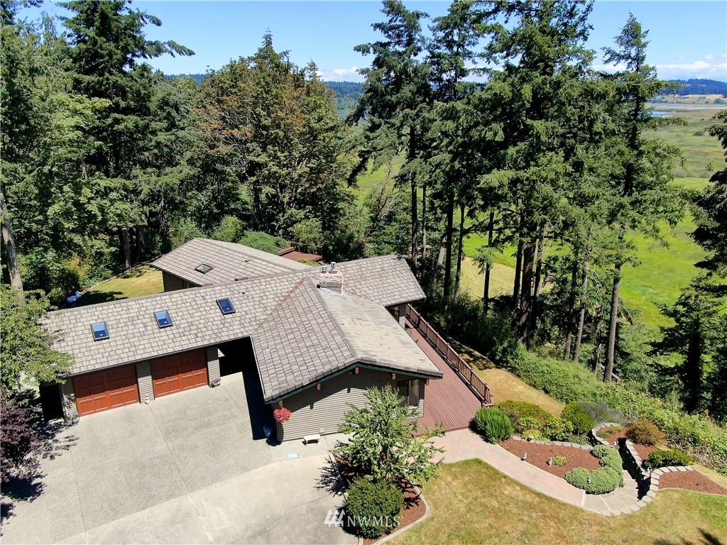 6188 Double Bluff Road Freeland, WA 98249 - Photo 4 of 40 an aerial view of a house with yard and trampoline