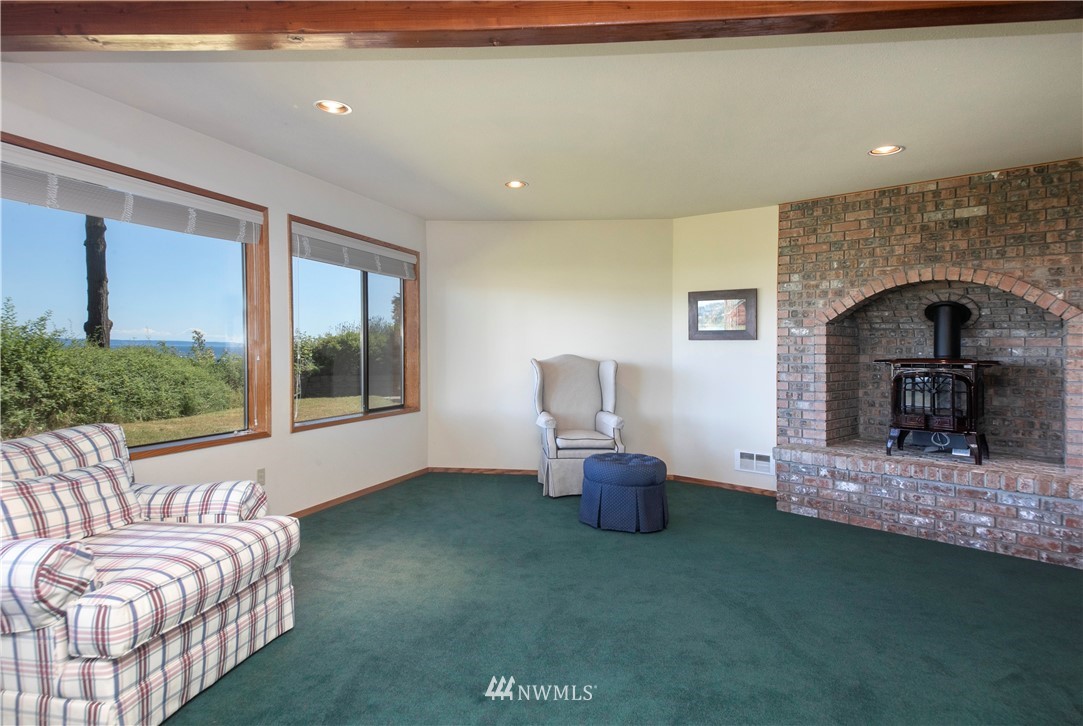 6188 Double Bluff Road Freeland, WA 98249 - Photo 33 of 40 a living room with furniture and a fireplace