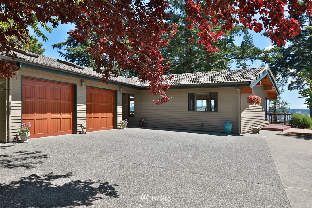 6188 Double Bluff Road Freeland, WA 98249 - Photo 5 of 40 a front view of a house with a tree