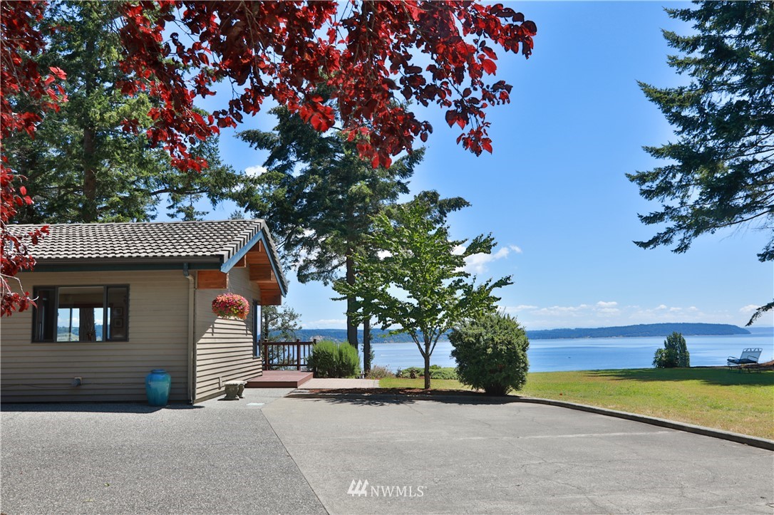 6188 Double Bluff Road Freeland, WA 98249 - Photo 6 of 40 a front view of a house with a yard and garage