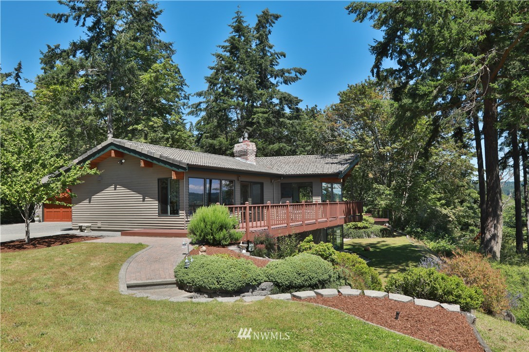 6188 Double Bluff Road Freeland, WA 98249 - Photo 7 of 40 a front view of a house with a yard