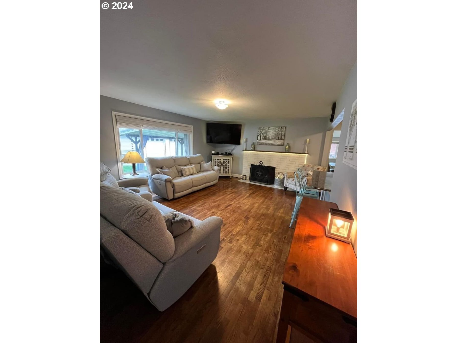 1516 Southwest 41st Street Pendleton, OR 97801 - Photo 2 of 20 a living room with furniture and a fireplace