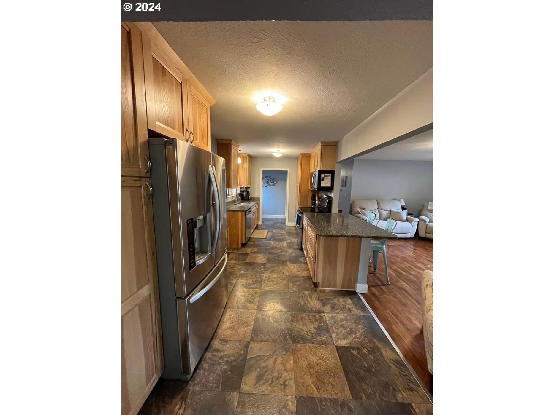 1516 Southwest 41st Street Pendleton, OR 97801 - Photo 5 of 20 a kitchen with refrigerator and chairs