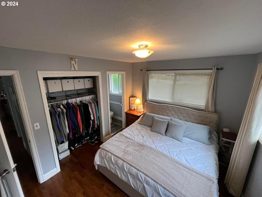 1516 Southwest 41st Street Pendleton, OR 97801 - Photo 7 of 20 a bedroom with a large bed and a large mirror