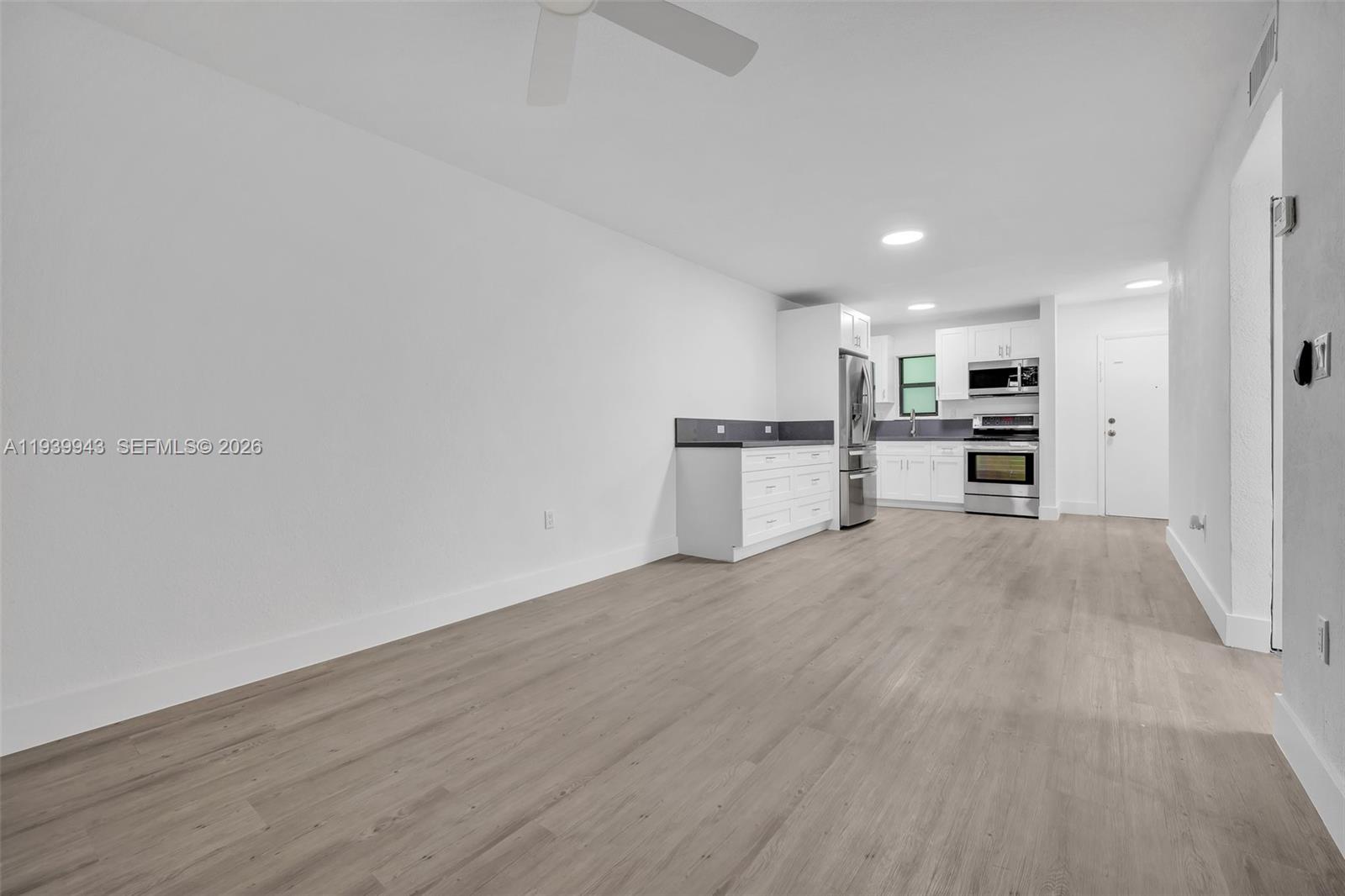 1530 Southwest 2nd Street, Unit 301 Miami, FL 33135 - Photo 11 of 12 a view of a kitchen with wooden floor and electronic appliances