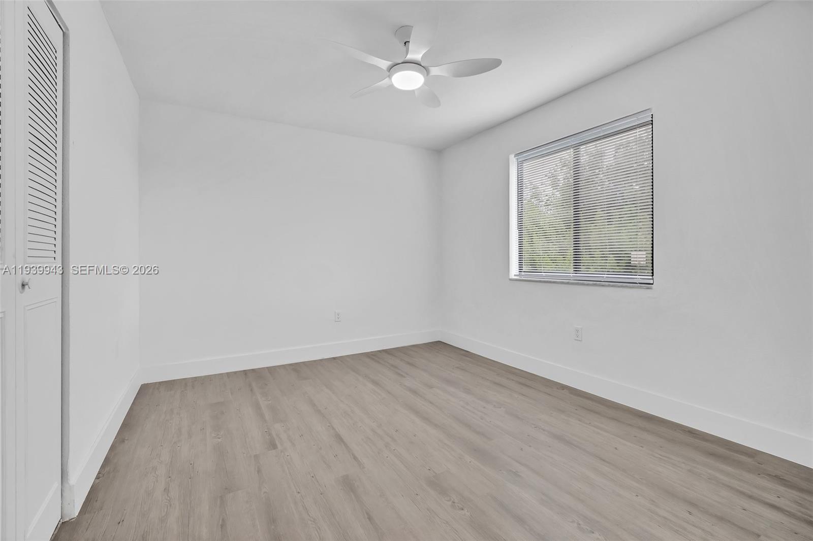 1530 Southwest 2nd Street, Unit 301 Miami, FL 33135 - Photo 12 of 12 an empty room with wooden floor and windows