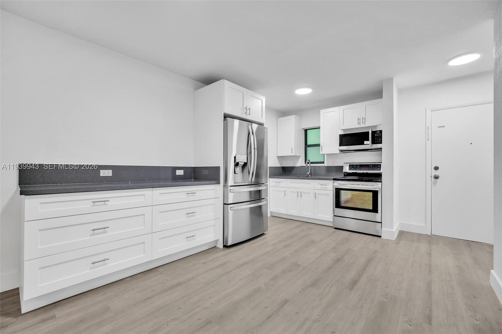 1530 Southwest 2nd Street, Unit 301 Miami, FL 33135 - Photo 6 of 12 a kitchen with stove cabinets and stainless steel appliances