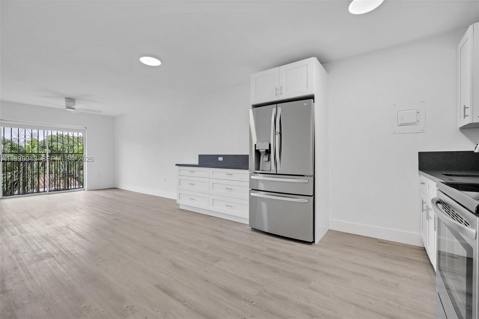 1530 Southwest 2nd Street, Unit 301 Miami, FL 33135 - Photo 8 of 12 a view of a kitchen with wooden floor and electronic appliances