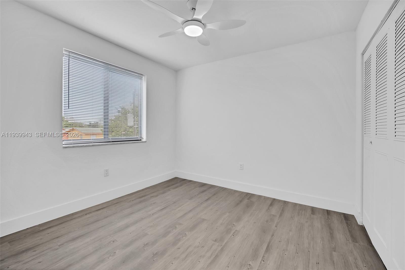 1530 Southwest 2nd Street, Unit 301 Miami, FL 33135 - Photo 10 of 12 wooden floor in an empty room with a window