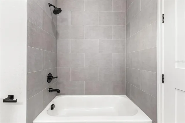 a bath tub sitting next to a white sink