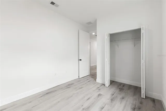 an empty room with wooden floor
