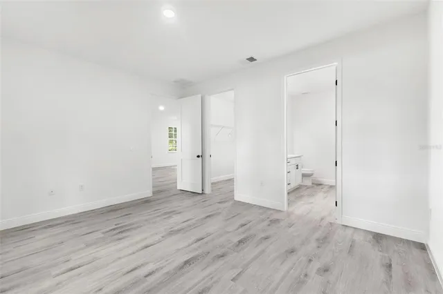 a view of an empty room and wooden floor