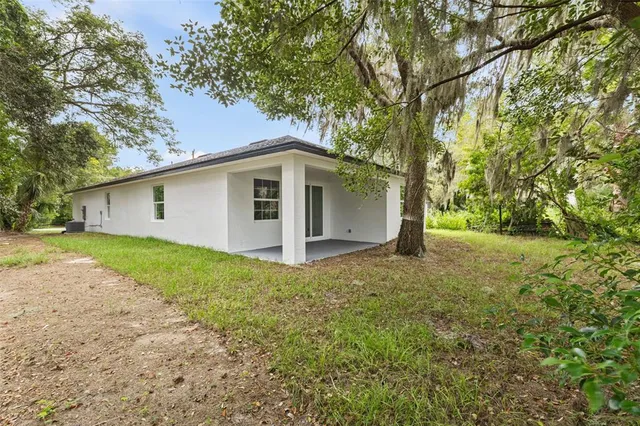 a front view of house with yard and trees