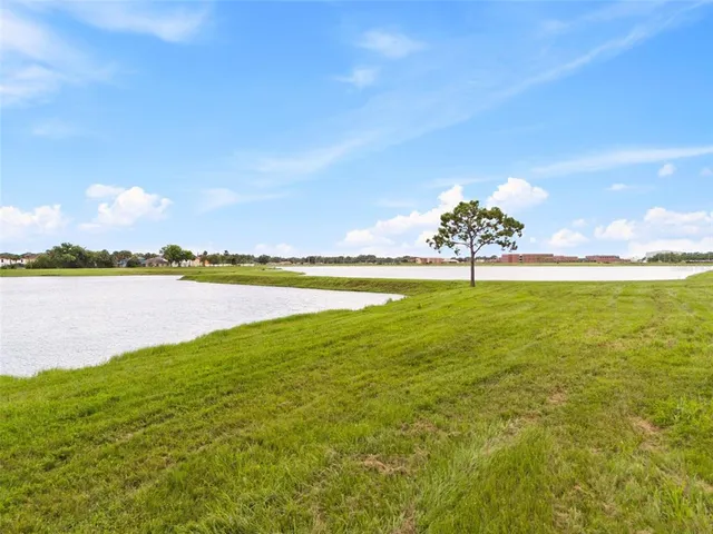 a view of a lake with a big yard