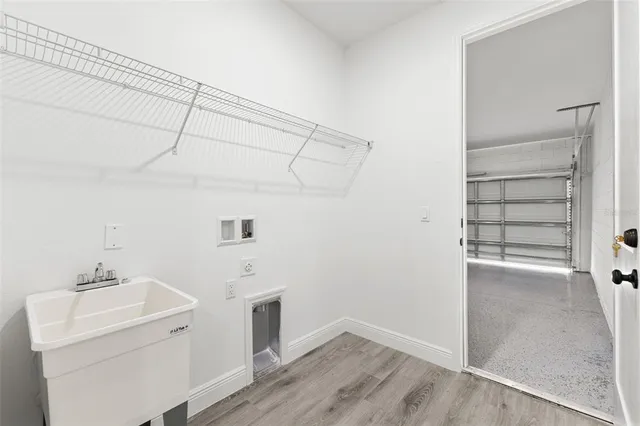 a view of a utility room with closet and wooden floor