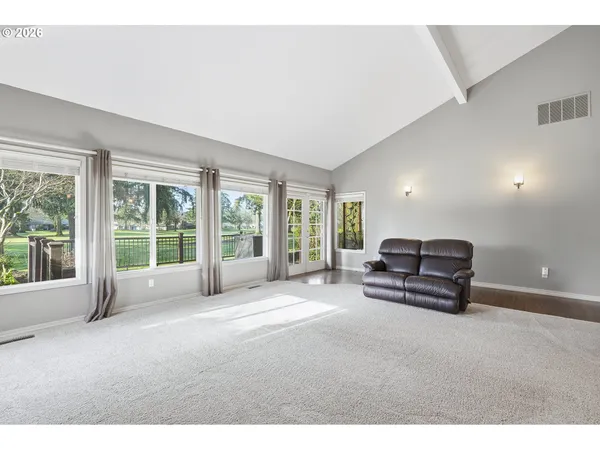 a dining room with furniture a chandelier and wooden floor