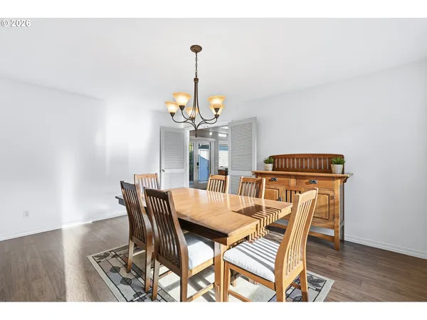 a kitchen with stainless steel appliances granite countertop a stove top oven a sink a counter space and dining table