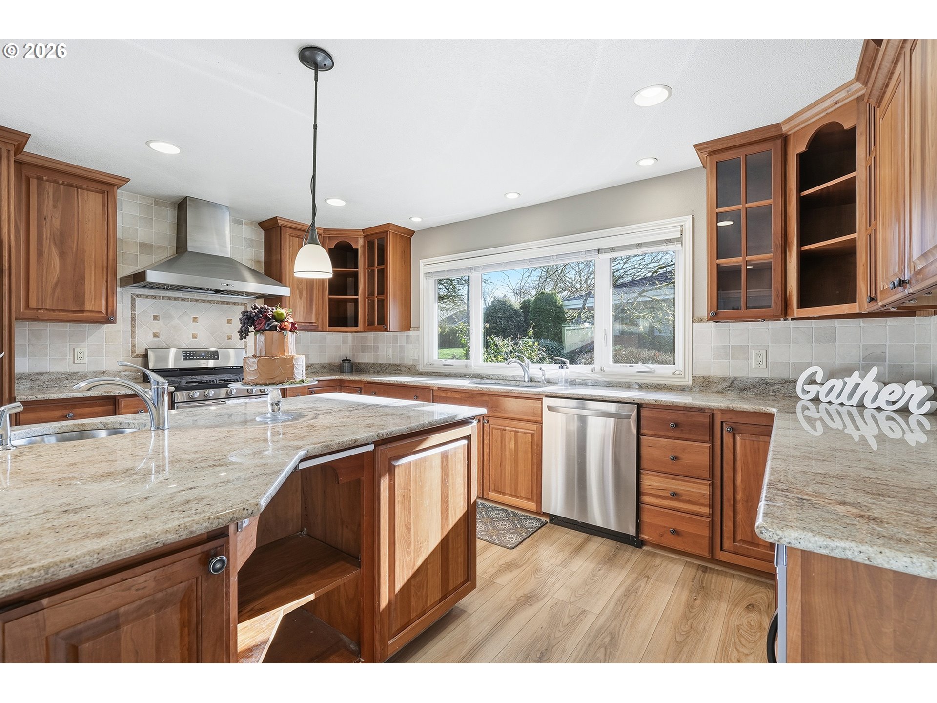 32565 Southwest Lake Point Court Wilsonville, OR 97070 - Photo 19 of 48 a kitchen with stainless steel appliances granite countertop a sink a stove a refrigerator wooden floor and cabinets