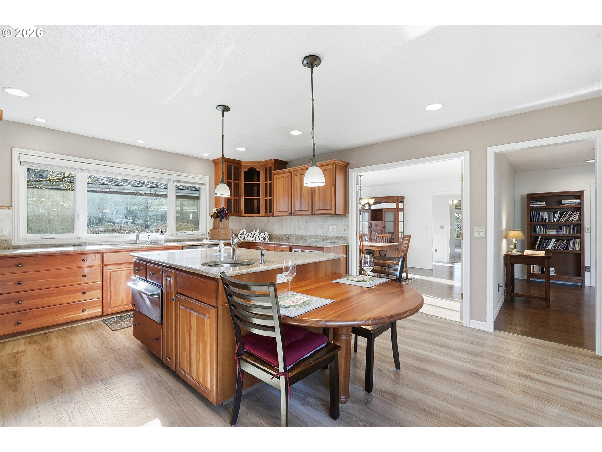 32565 Southwest Lake Point Court Wilsonville, OR 97070 - Photo 21 of 48 a kitchen with stainless steel appliances granite countertop a kitchen island a stove a table and chairs