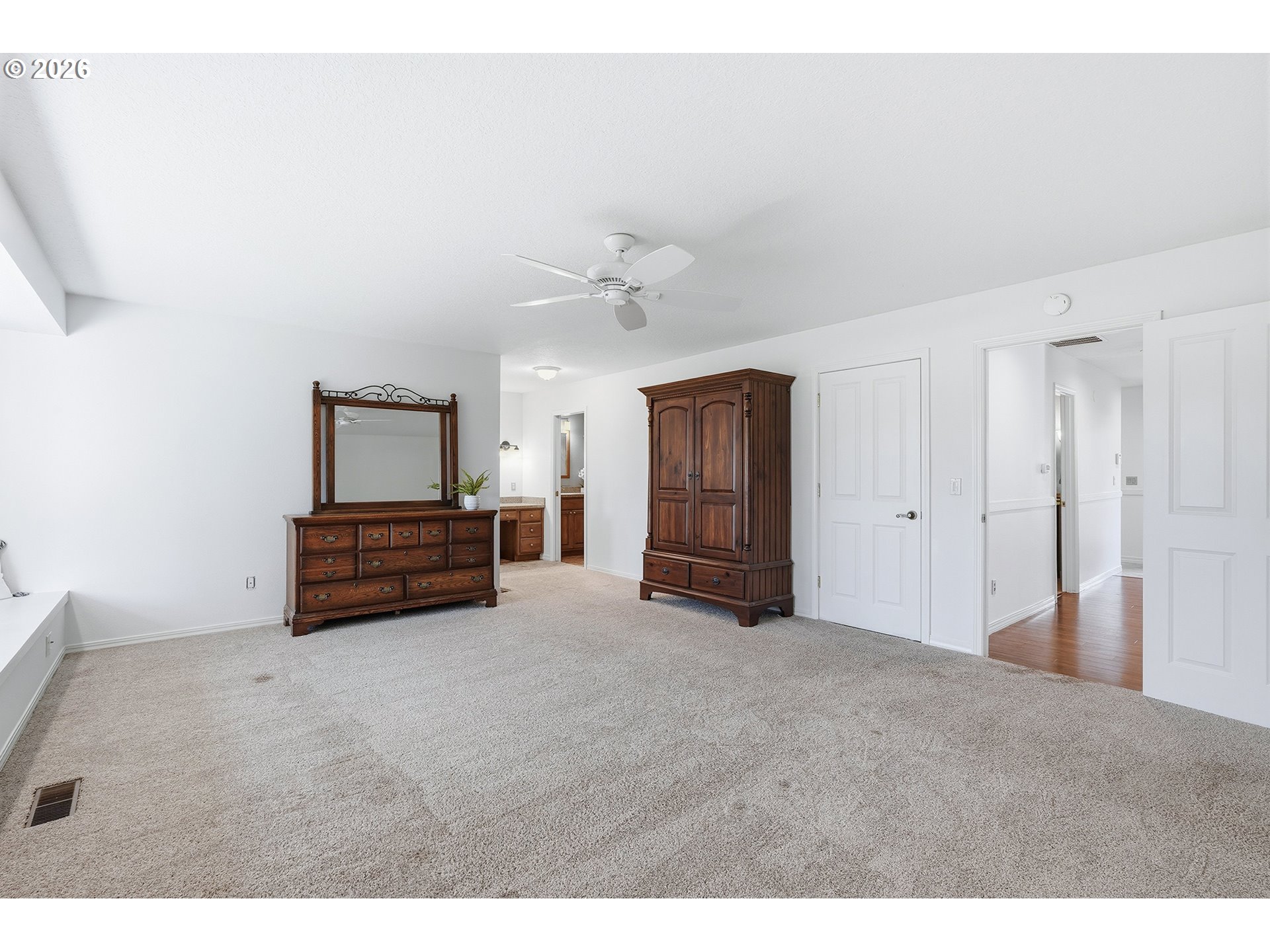 32565 Southwest Lake Point Court Wilsonville, OR 97070 - Photo 28 of 48 a spacious bedroom with a bed and a chandelier