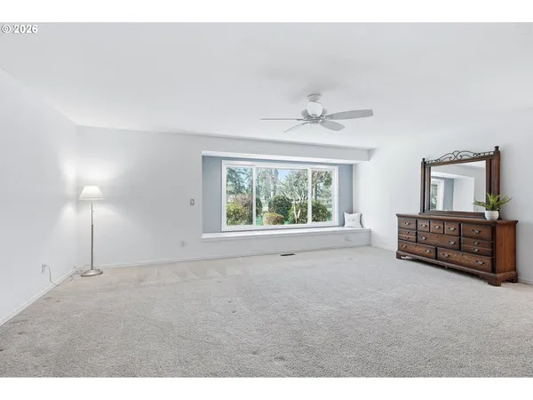 a spacious bedroom with a bed and a chandelier