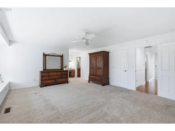 a bathroom with a sink a toilet and a large mirror