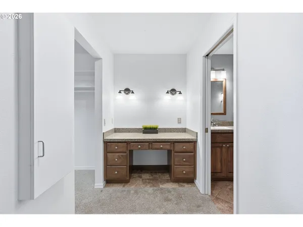 a bathroom with a granite countertop sink two mirror and a